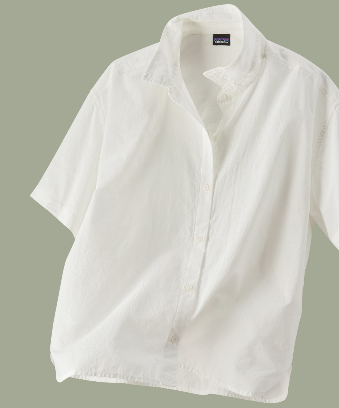 A studio shot of a button-down shirt that appears to be gently blowing in a light breeze.