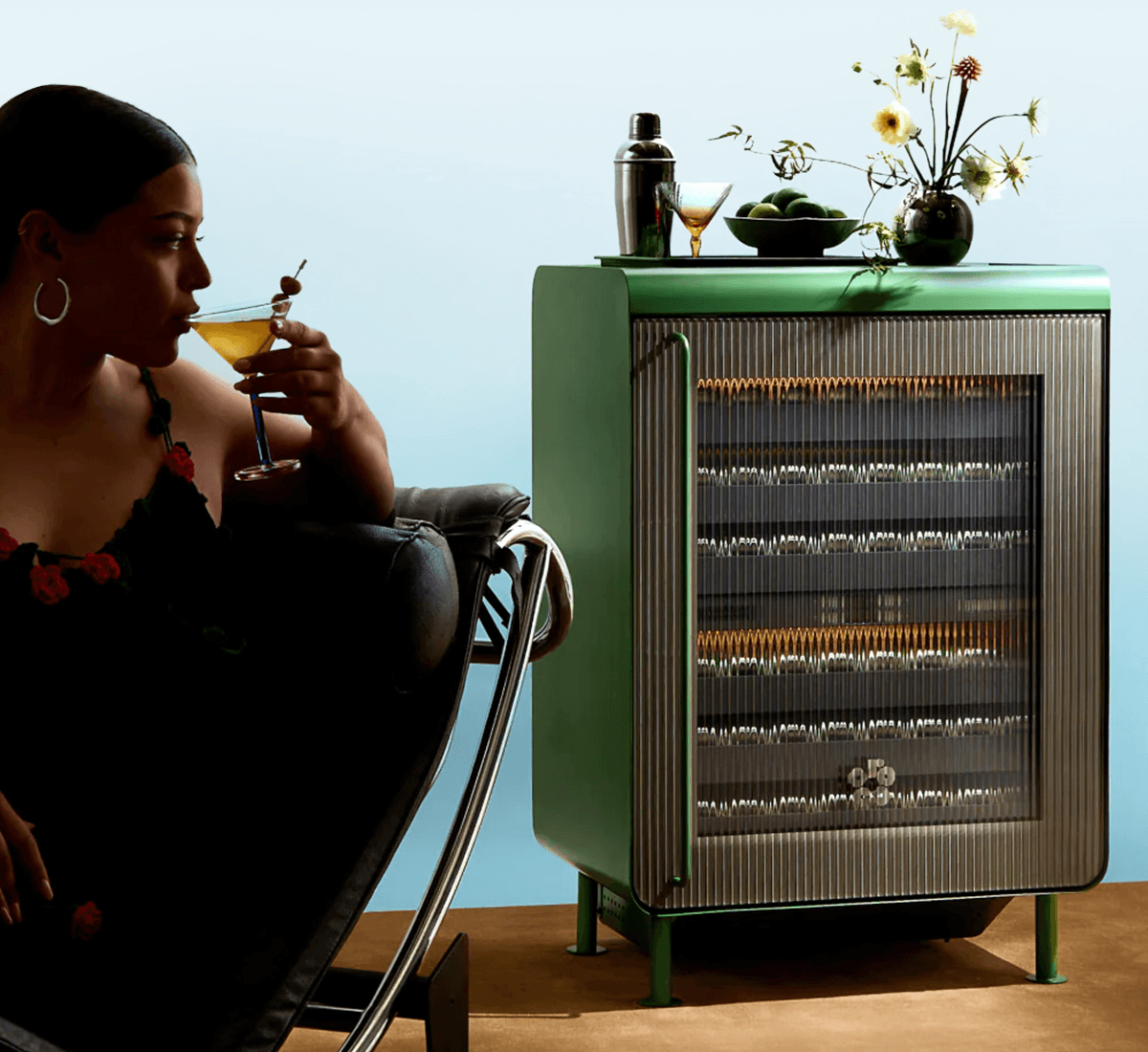 A woman sipping a martini in front of her Rocco fridge