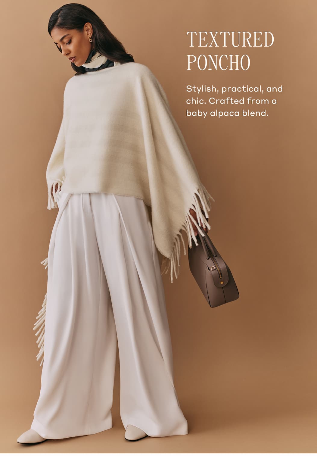 TEXTURED PONCHO Stylish, practical, and chic. Crafted from a baby alpaca blend.