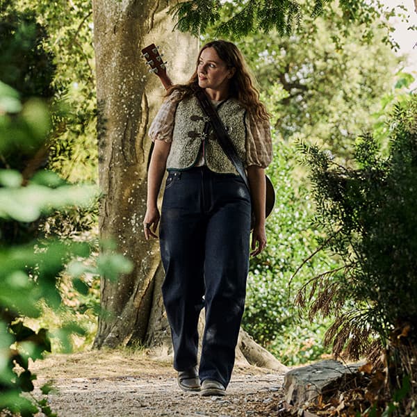 Photo of Mari walking through woodland