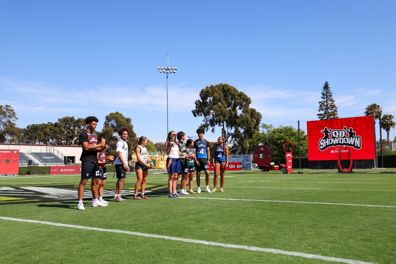 Athletes on the field at Overtime's QB Showdown.