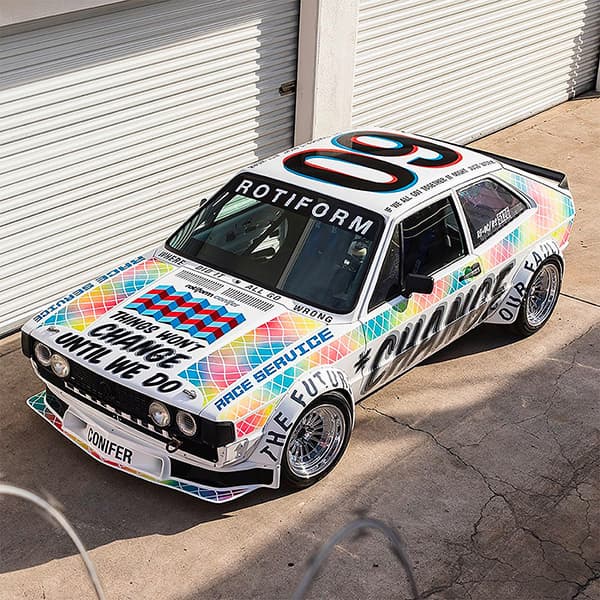 Painted white car with typography all over it.