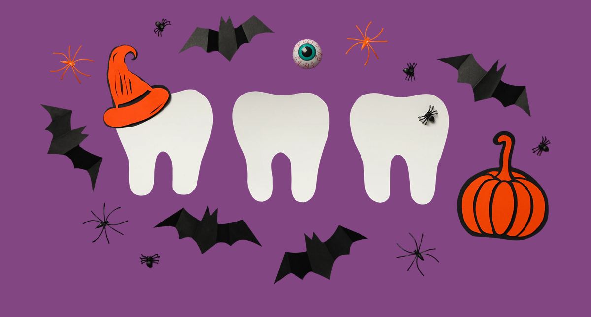 A wide, flat-lay Halloween illustration on a solid purple background shows three large white tooth shapes across the center, an orange pointed witch h...
