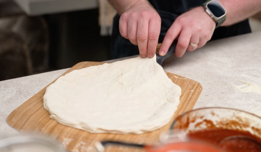 Pizza dough stretched on a peel