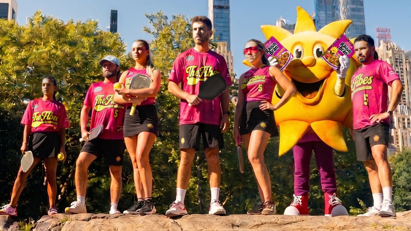 the New Jersey Fives pro pickleball team posing with the Raisin Bran sun mascot wearing jerseys reading 