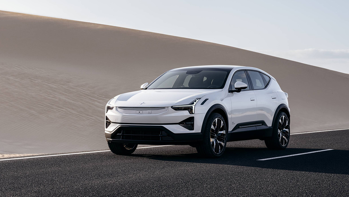 Front view of Polestar 3 driving on a road in the desert under clear sky.