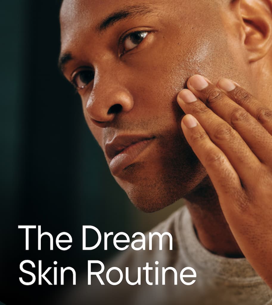 Man gently touching his cheek, showcasing healthy, clear skin