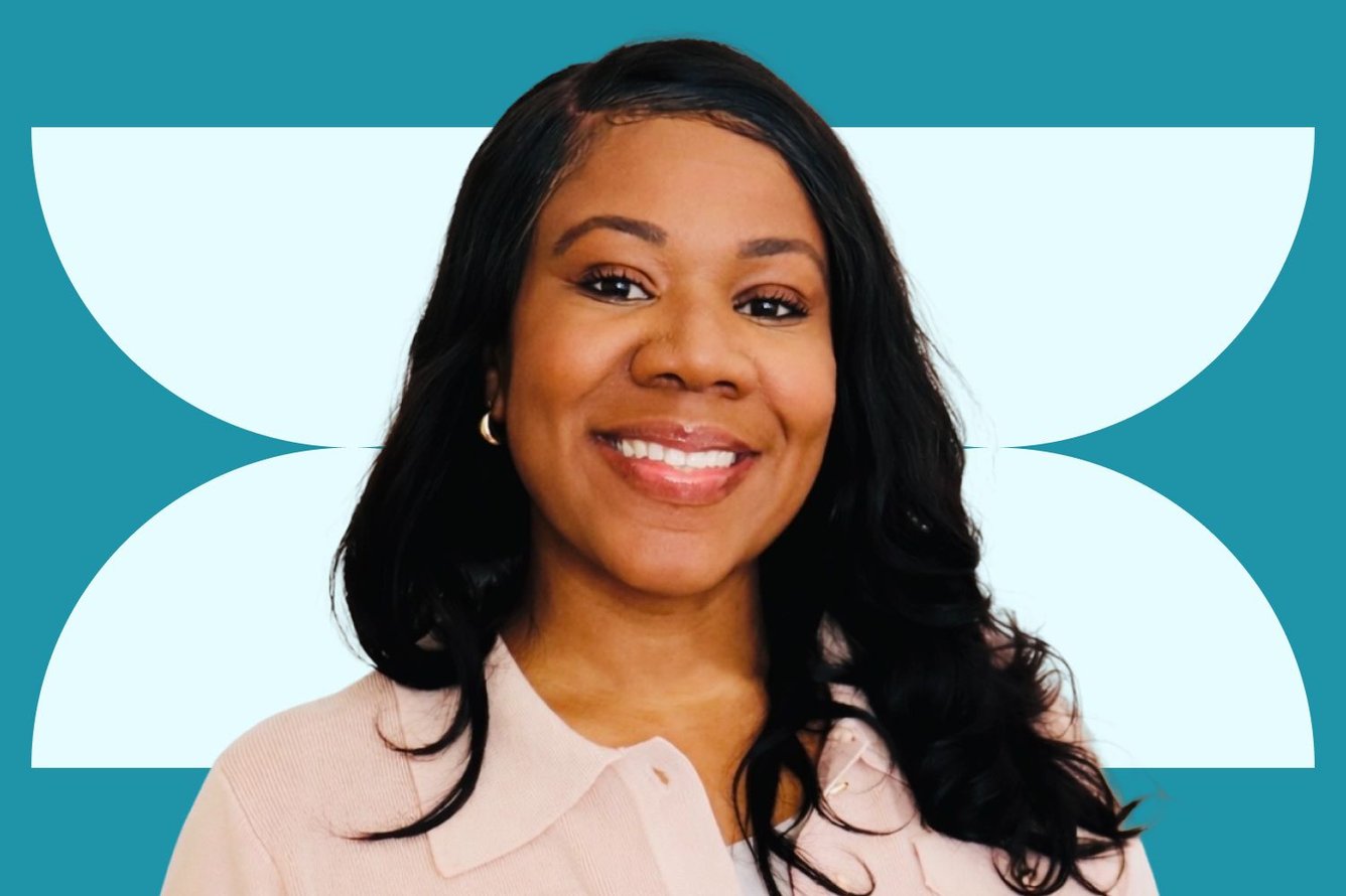Headshot of Daale Carter, a Black woman with wavy dark hair wearing a light pink blouse smiling enthusiastically at the camera.