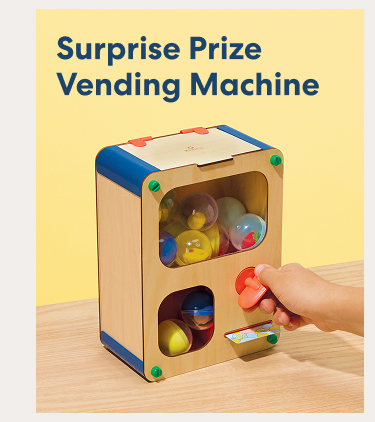 Surprise Prize Vending Machine. A wooden vending machine filled with colorful prize capsules as a hand turns the dispenser.
