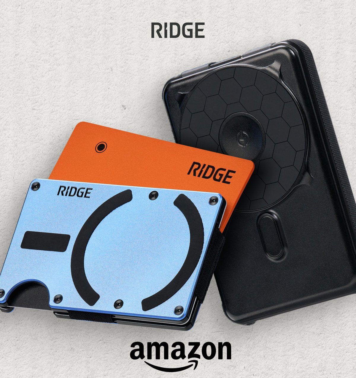 Ridge on Amazon. A blue wallet, an orange tracker card and a black power bank.
