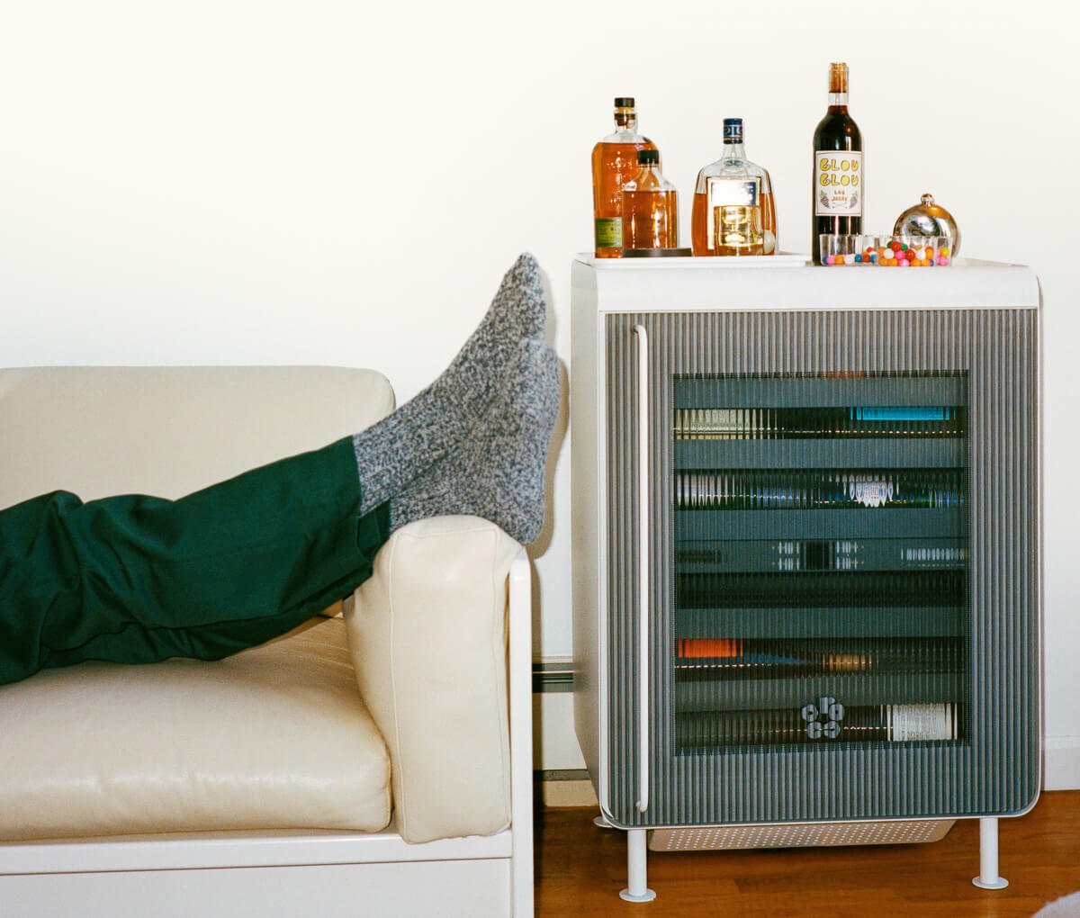 Feet up on a couch next to the Rocco Fridge