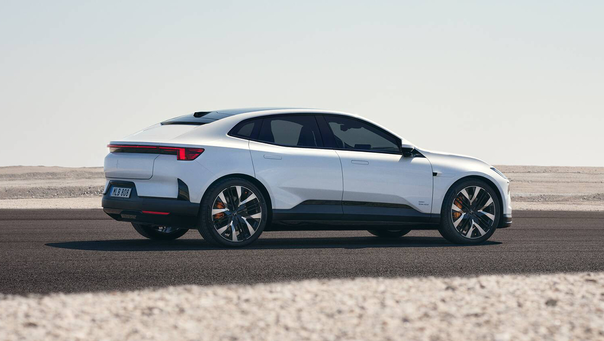Side view of Polestar 4 coupe driving in an open landscape.