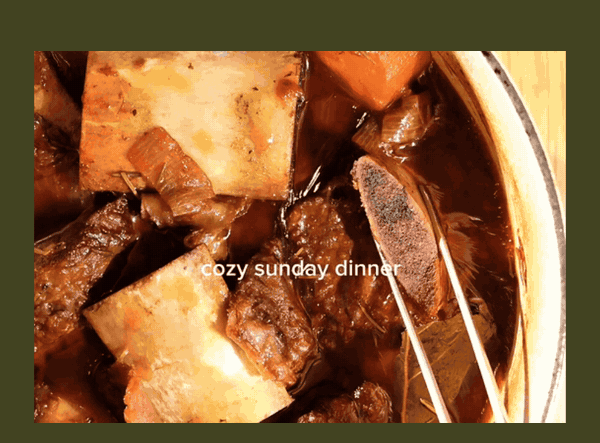 Short ribs, carrots and parsnips braising in a pot, cozy Sunday dinner