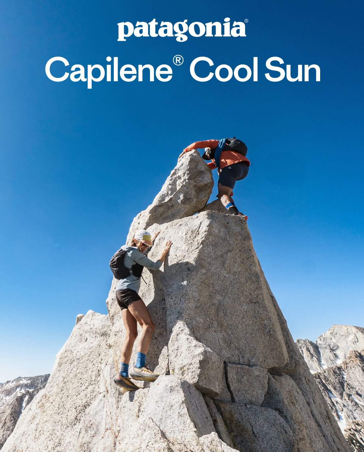 Patagonia. Two people summit a granite spire on a ridge.
