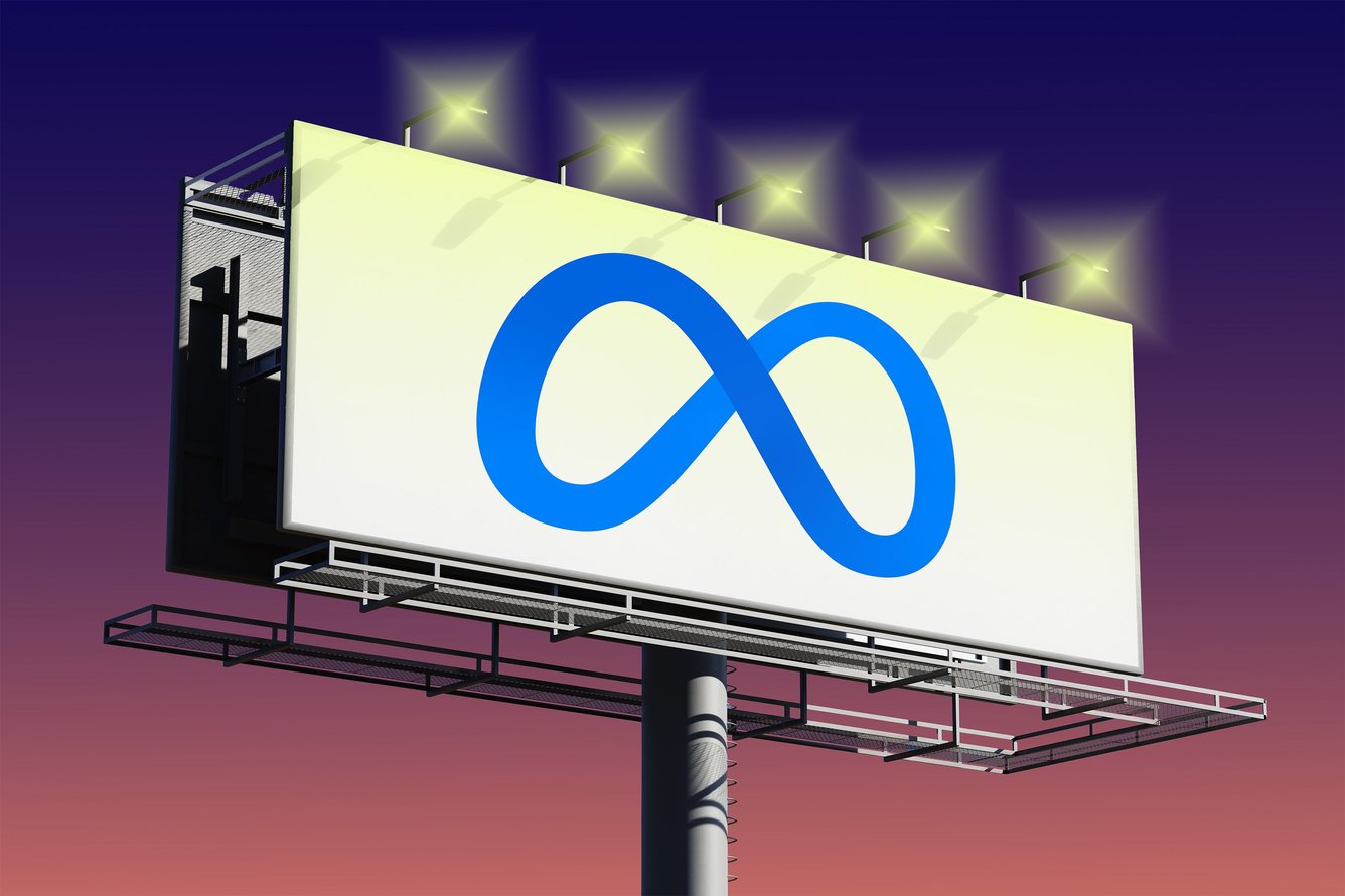 Meta logo on a billboard with lights against blue and orange