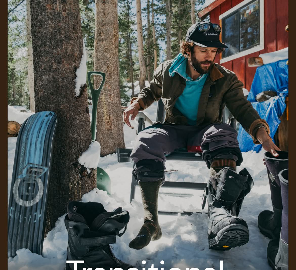 Patagonia. A person sits in a chair alongside a cabin in a snowy forest changing from snowboard boots to snow boots.