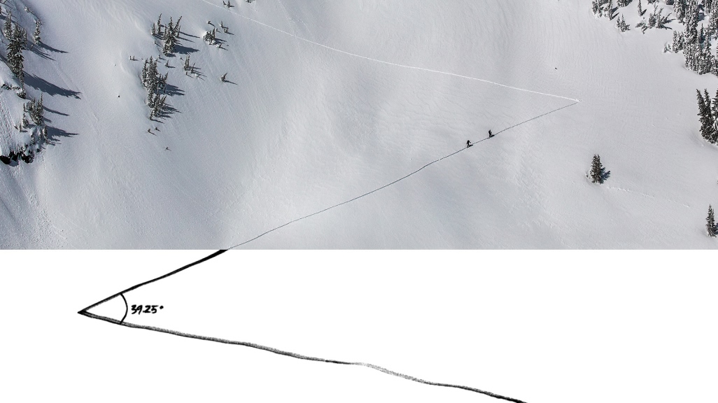Two backcountry skiers climbing up a skintrack.